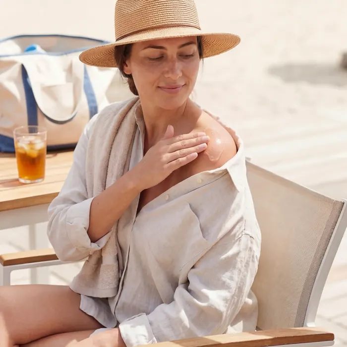 Applying aloe gel on the shoulder after the beach